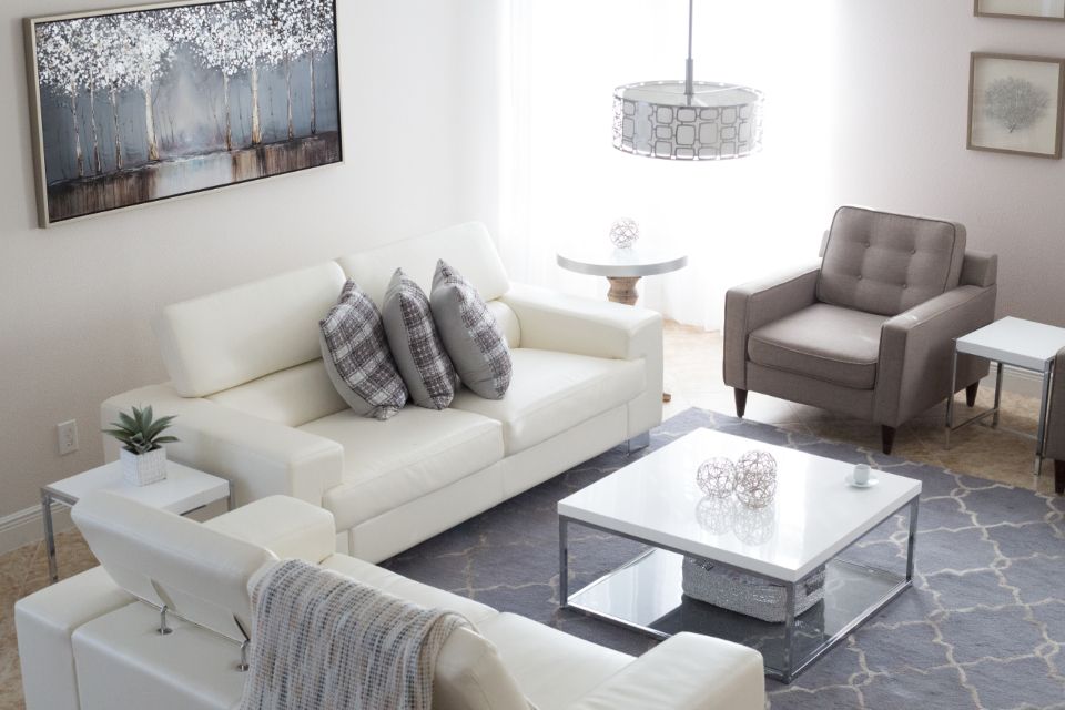 Hall with white sofas and a grey rug